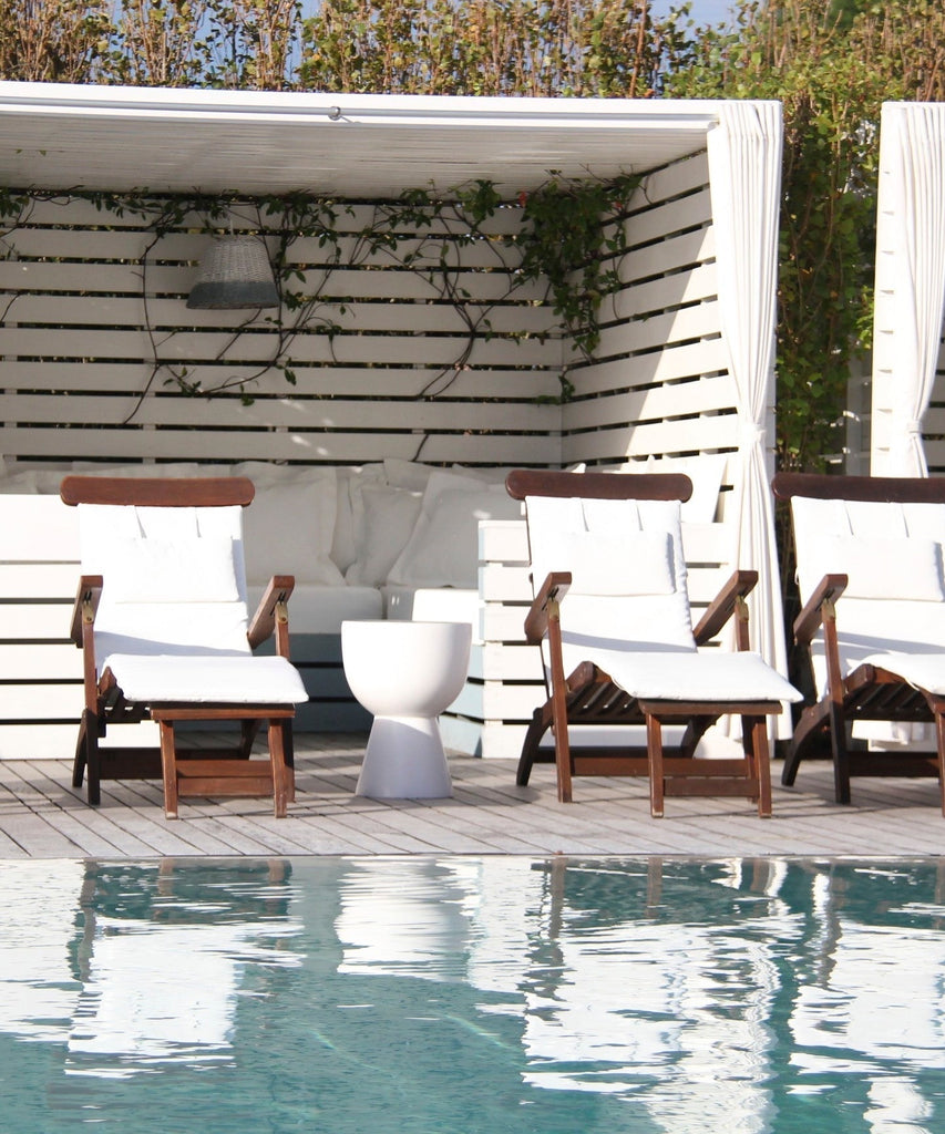 Seating on a Natural Wood Pool Deck, Cabanas with growing Jazmin ivy by MEM Interiors